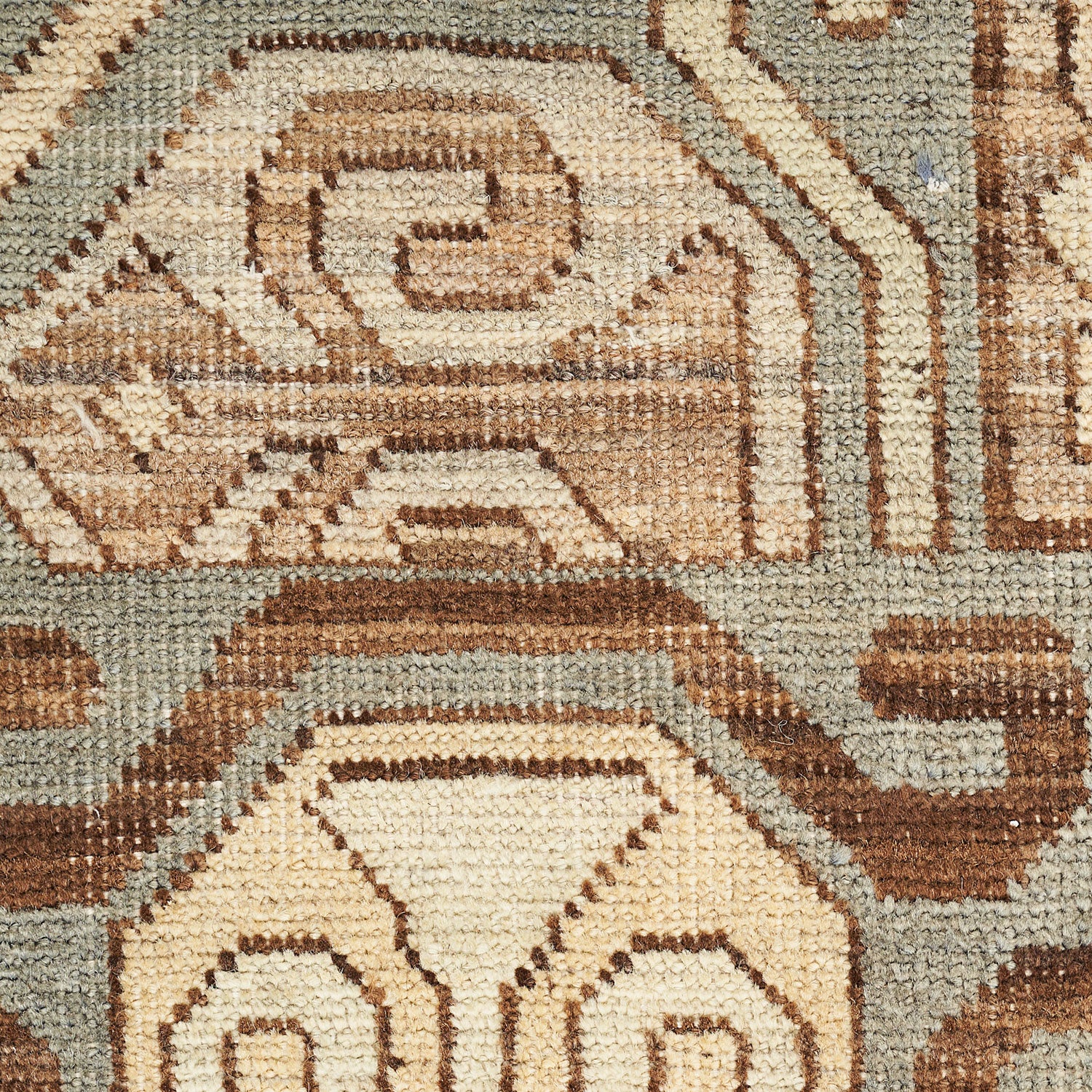 Close-up of a hand-woven rug showcasing a meticulously crafted geometric pattern.