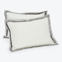 Two modern rectangular pillows with contrasting light and dark pillowcases.