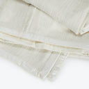 Neatly folded, lightweight, off-white cloths with a breathable, open weave.