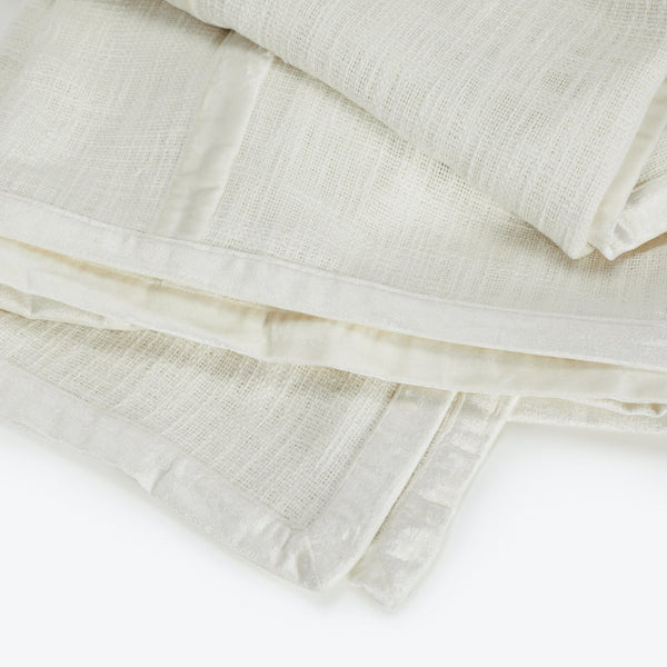 Neatly folded, lightweight, off-white cloths with a breathable, open weave.