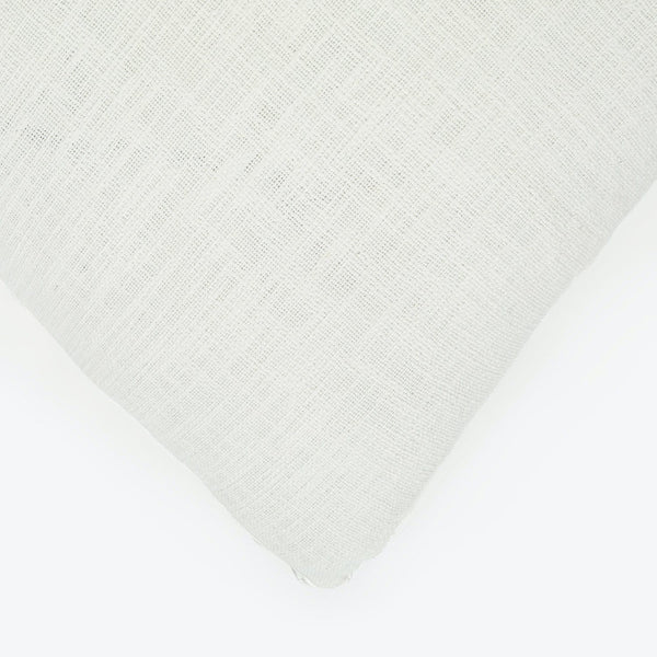 Close-up of white textile with visible weave pattern and texture.