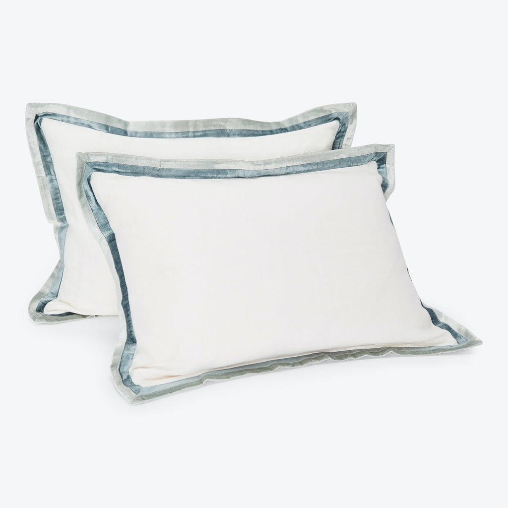 Two rectangular pillows with soft, detailed flange edges in blue-grey.