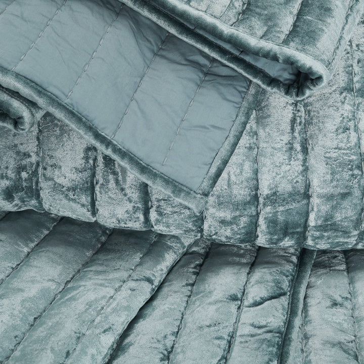 Close-up of a plush, quilted fabric in shades of blue