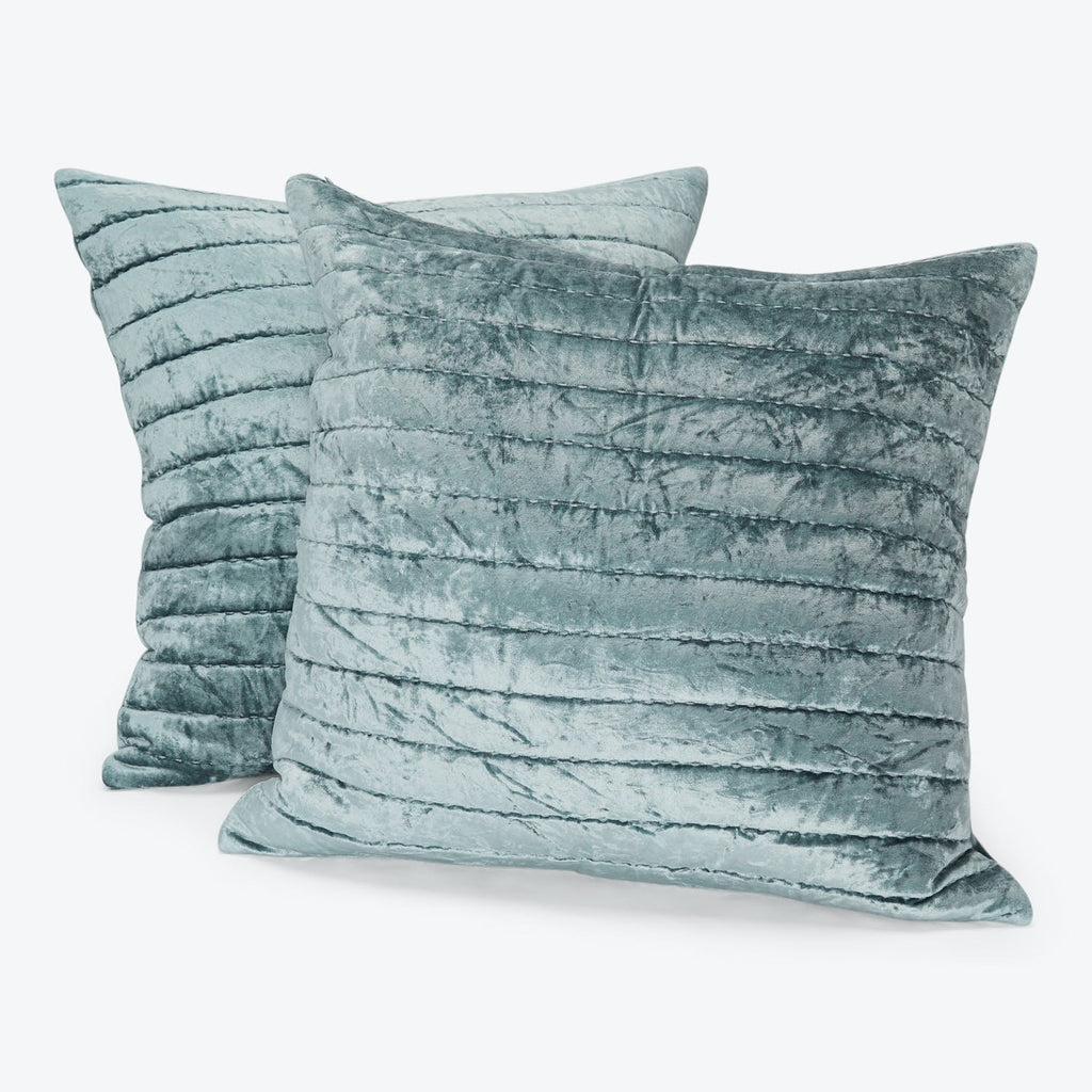 Two soft, ribbed, velvet pillows in muted blue for home decor.