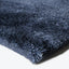 Close-up of navy blue plush fabric with soft, thick texture.
