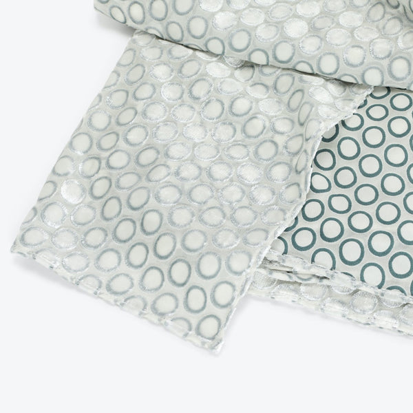 Textured and solid circular fabric swatches with frayed edges.
