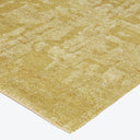 Close-up of a golden carpet with regular geometric textured pattern.