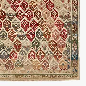 Intricate antique rug showcases harmonious geometric pattern with vibrant colors.
