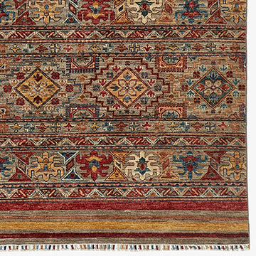 Intricately designed, handwoven rug with warm colors and traditional motifs.