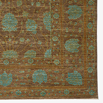 Exquisite Persian-inspired rug showcases intricate teal floral motifs on warm brown background.