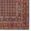 Intricately patterned rug showcases rich colors and geometric motifs.