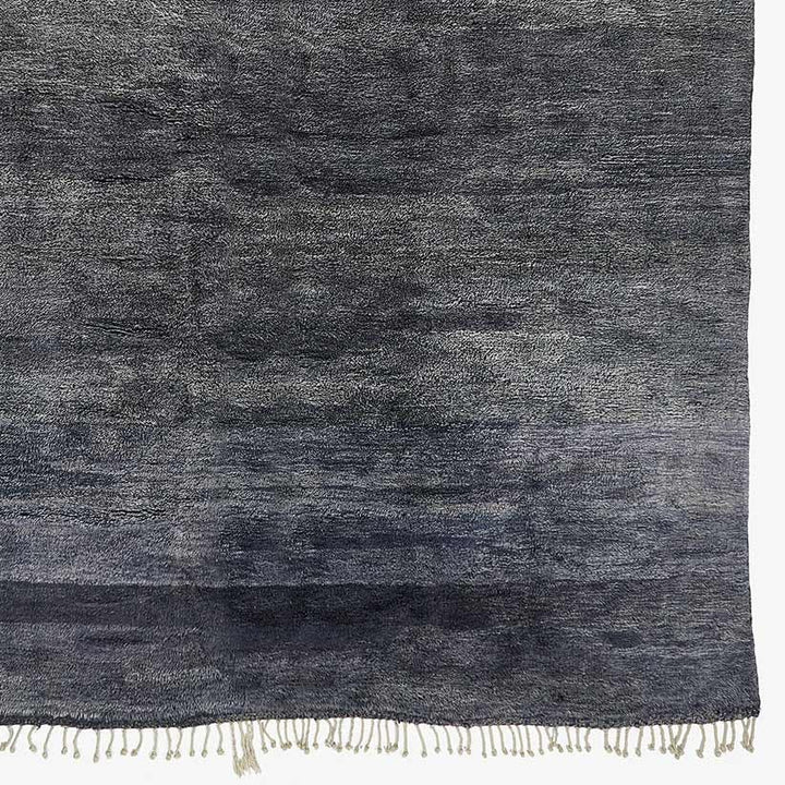 Elegant textile with gradient hues and fringe, perfect for home décor.