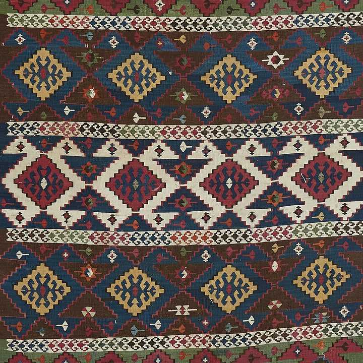 Colorful handcrafted rug showcases symmetrical geometric motifs in various cultures.