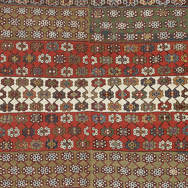 Highly ornate textile pattern with rich colors and intricate motifs.
