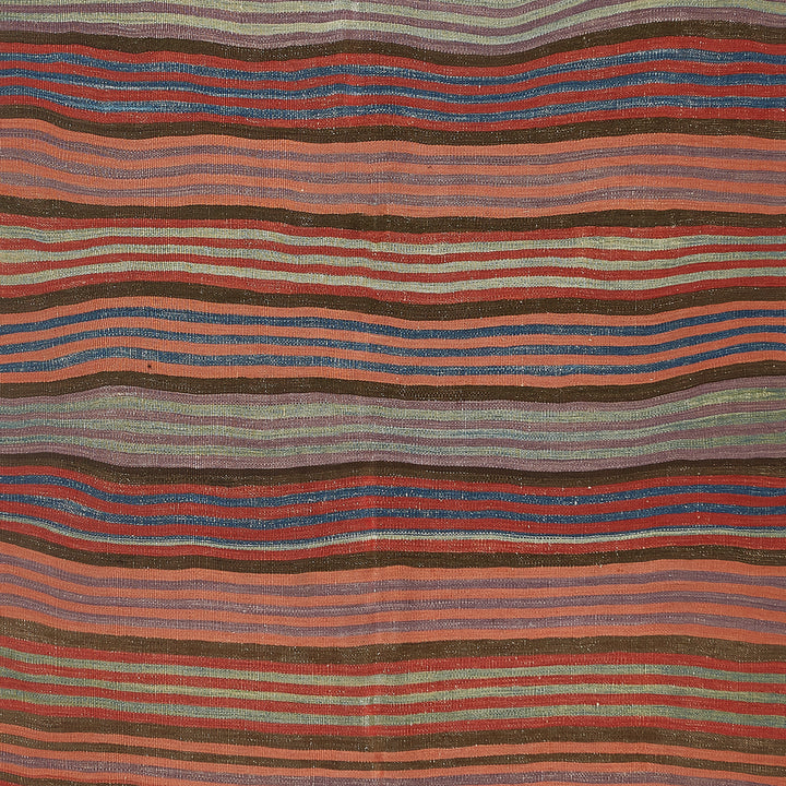 Visually dynamic handmade textile showcases intricate patterns and vibrant colors.