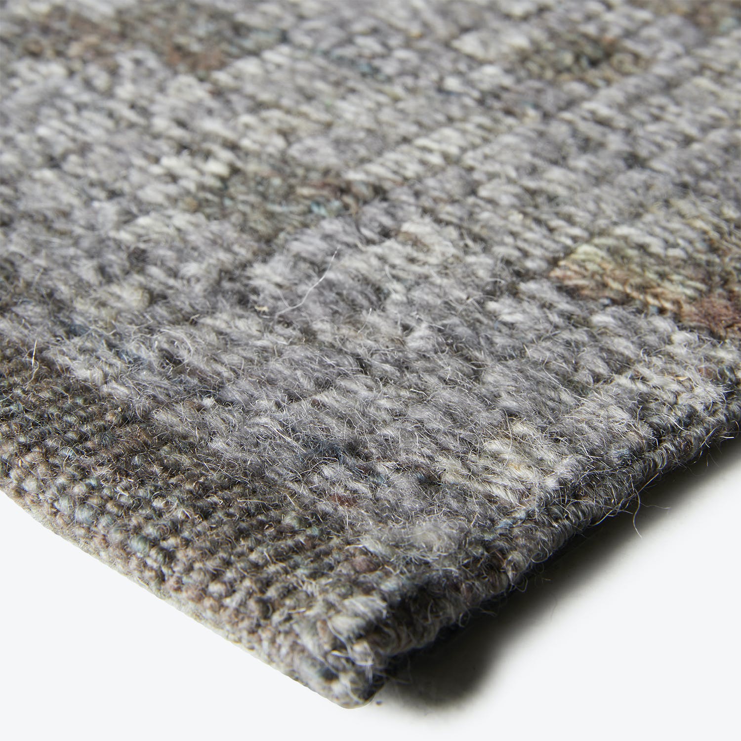Close-up of textured fabric, possibly wool blend, with tight weave.