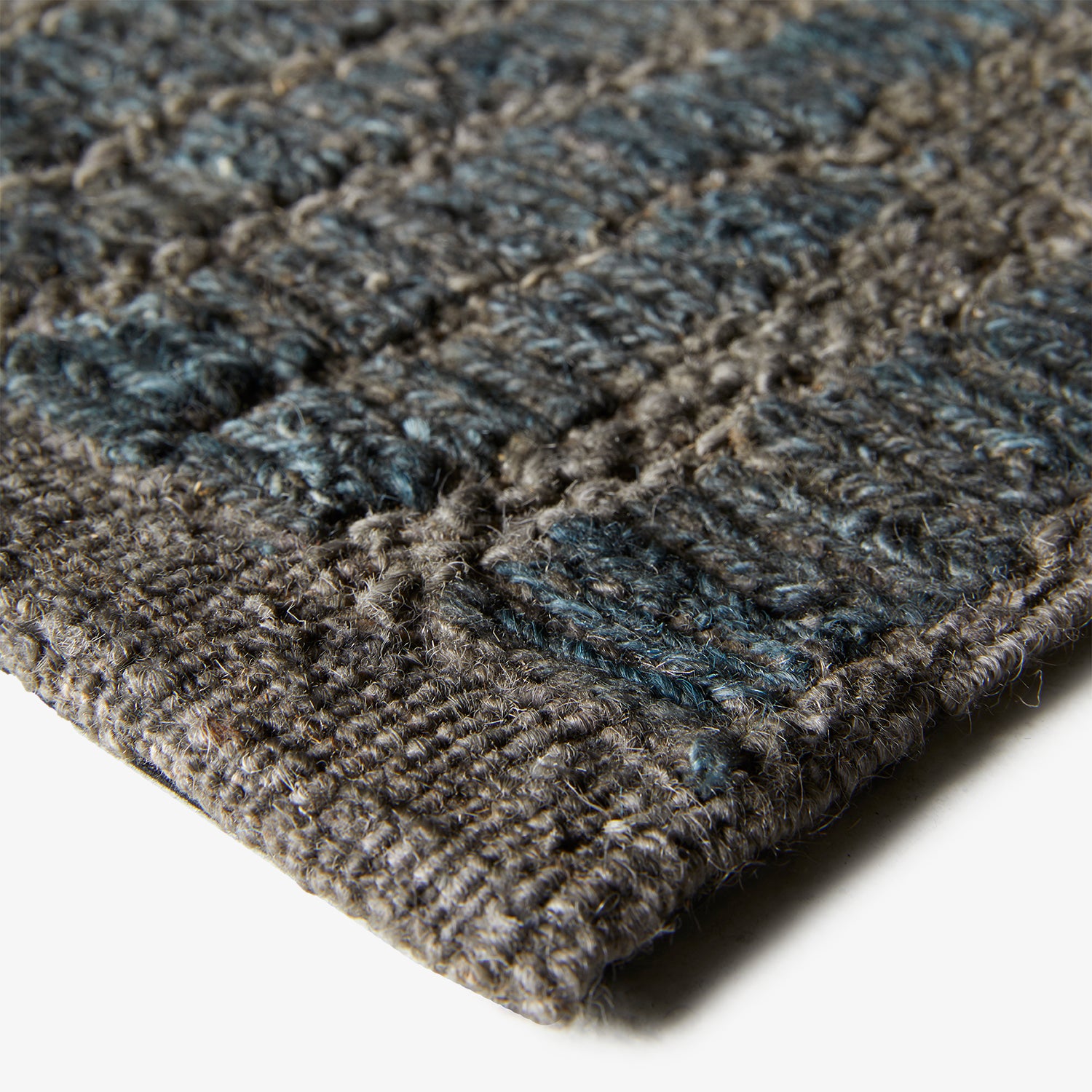 Close-up of a dense, looped fabric in shades of gray.