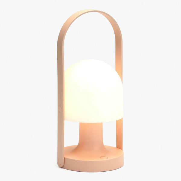 Minimalist portable lamp with warm diffuser and easy-carry handle.