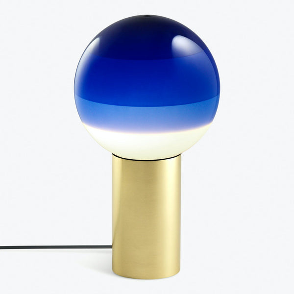 Contemporary table lamp with circular globe and luxurious gold base.
