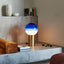 Stylish and modern interior scene featuring a golden half-blue lamp.
