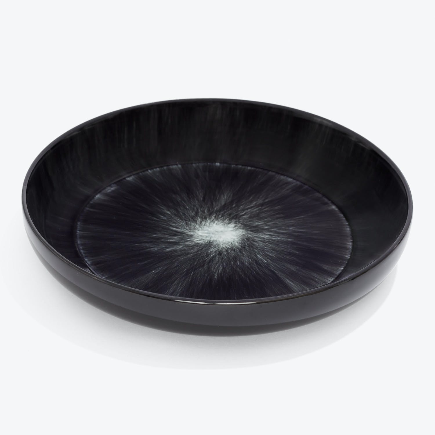 Black plate with unique starburst design, perfect for serving food