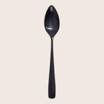 Contemporary glossy black spoon with a subtle curved reflection.