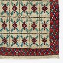 Traditional Middle Eastern or Central Asian rug with intricate geometric motifs and vibrant colors.