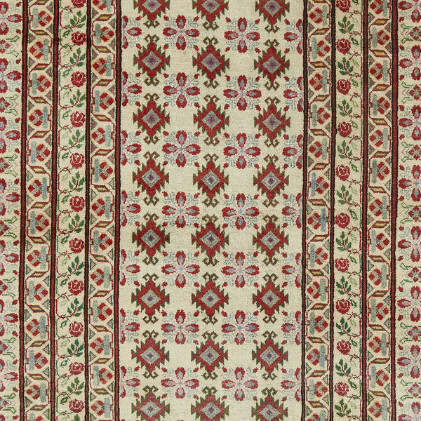 Traditional patterned carpet with geometric and floral design in rich colors