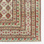 Traditional patterned carpet featuring floral and geometric motifs in vibrant colors.