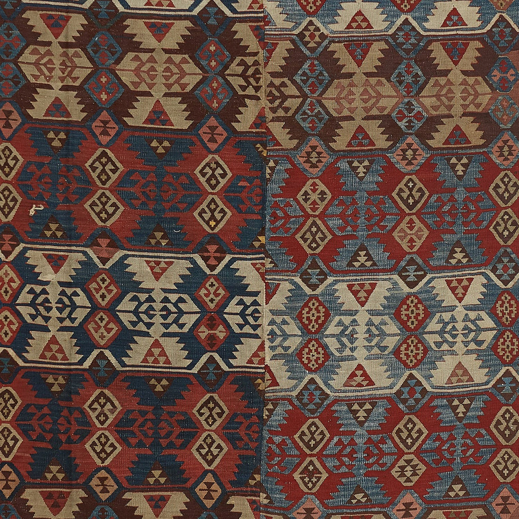 Intricate handwoven rug showcases symmetrical geometric motifs in vibrant colors.