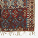 Traditional woven rug featuring geometric patterns in vibrant colors.