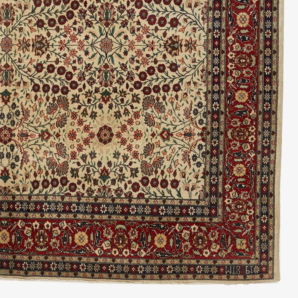 Intricate floral rug with harmonious design and richly decorated border.