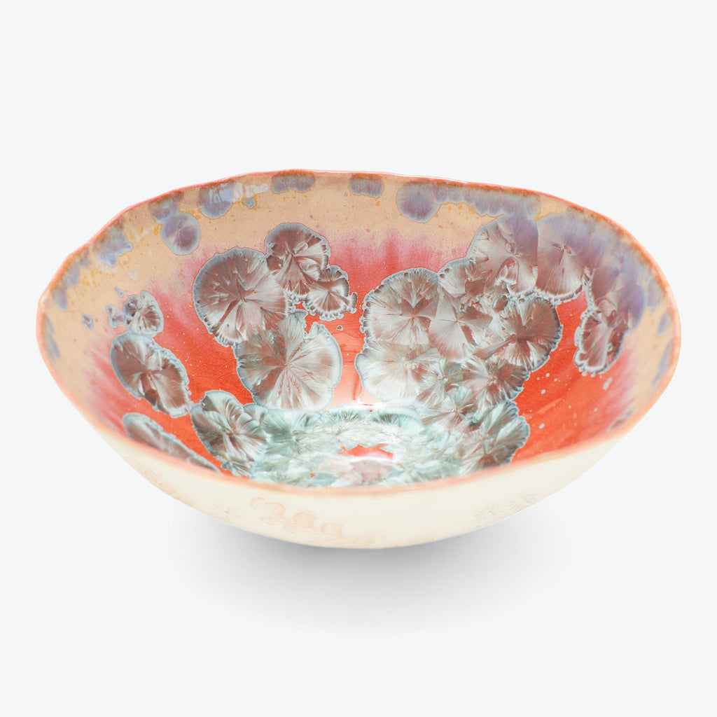 Handcrafted ceramic bowl with intricate floral pattern in vibrant colors.