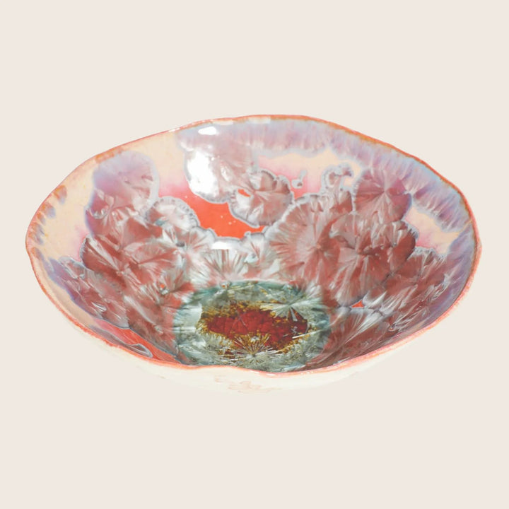 Vibrantly designed handmade bowl showcases intricate floral motifs and unique glazing techniques.