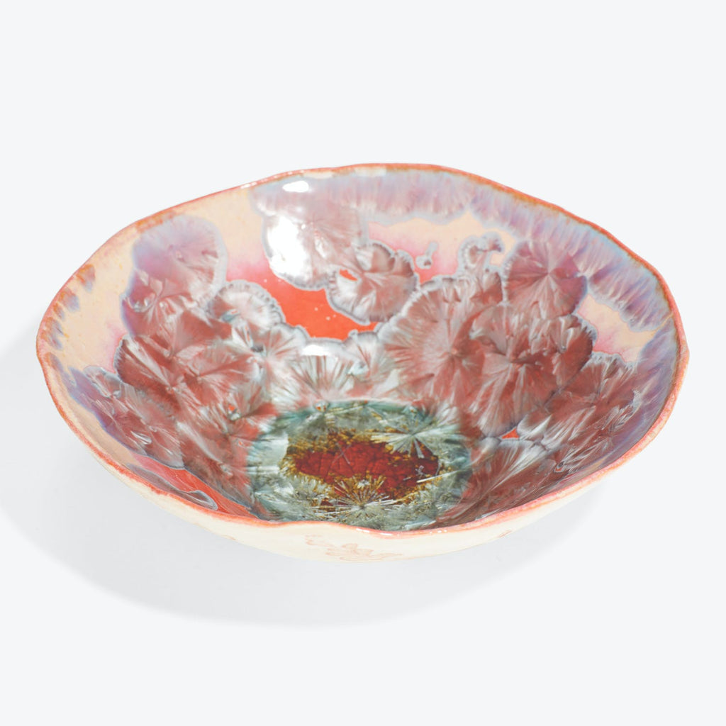 Vibrantly designed handmade bowl showcases intricate floral motifs and unique glazing techniques.