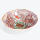 Vibrantly designed handmade bowl showcases intricate floral motifs and unique glazing techniques.