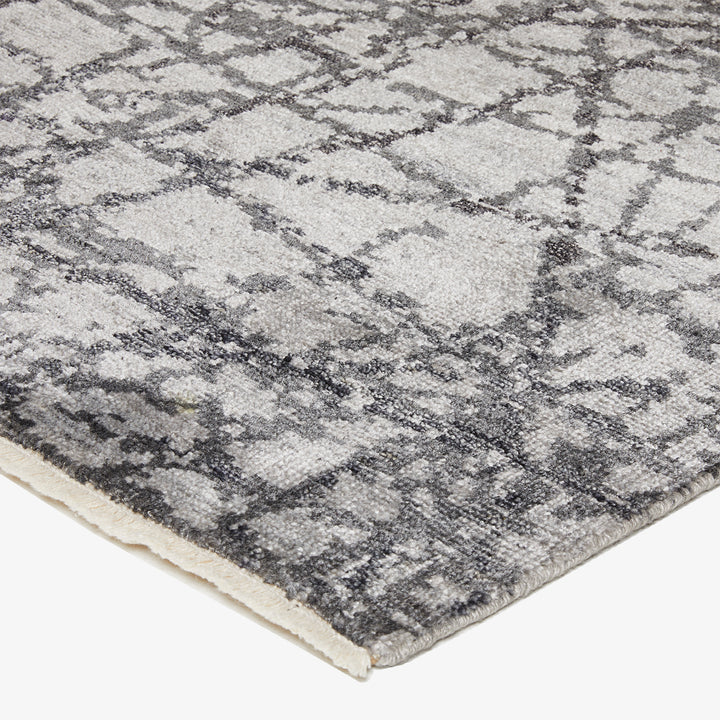 Close-up of a modern, abstract rug with marbled design.