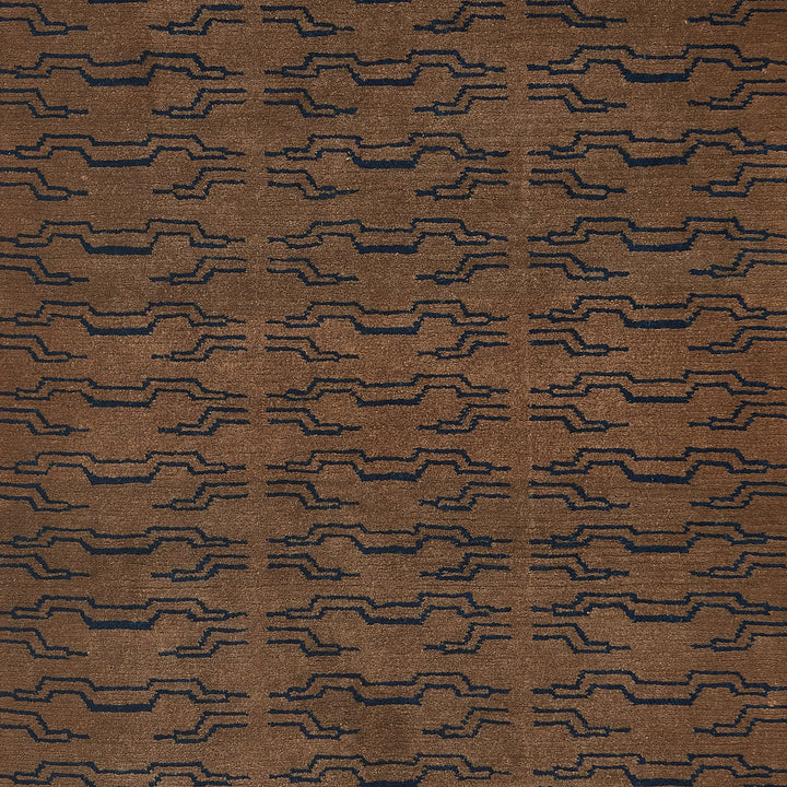 Close-up of a dark brown fabric with blue geometric pattern.