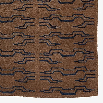 Traditional woven rug showcasing a structured zigzag pattern in blue