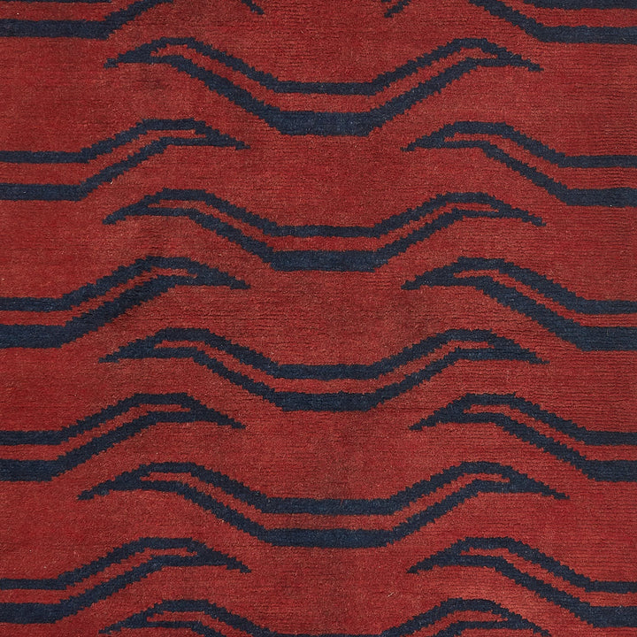 Close-up of bold geometric textile in rich red and blue.