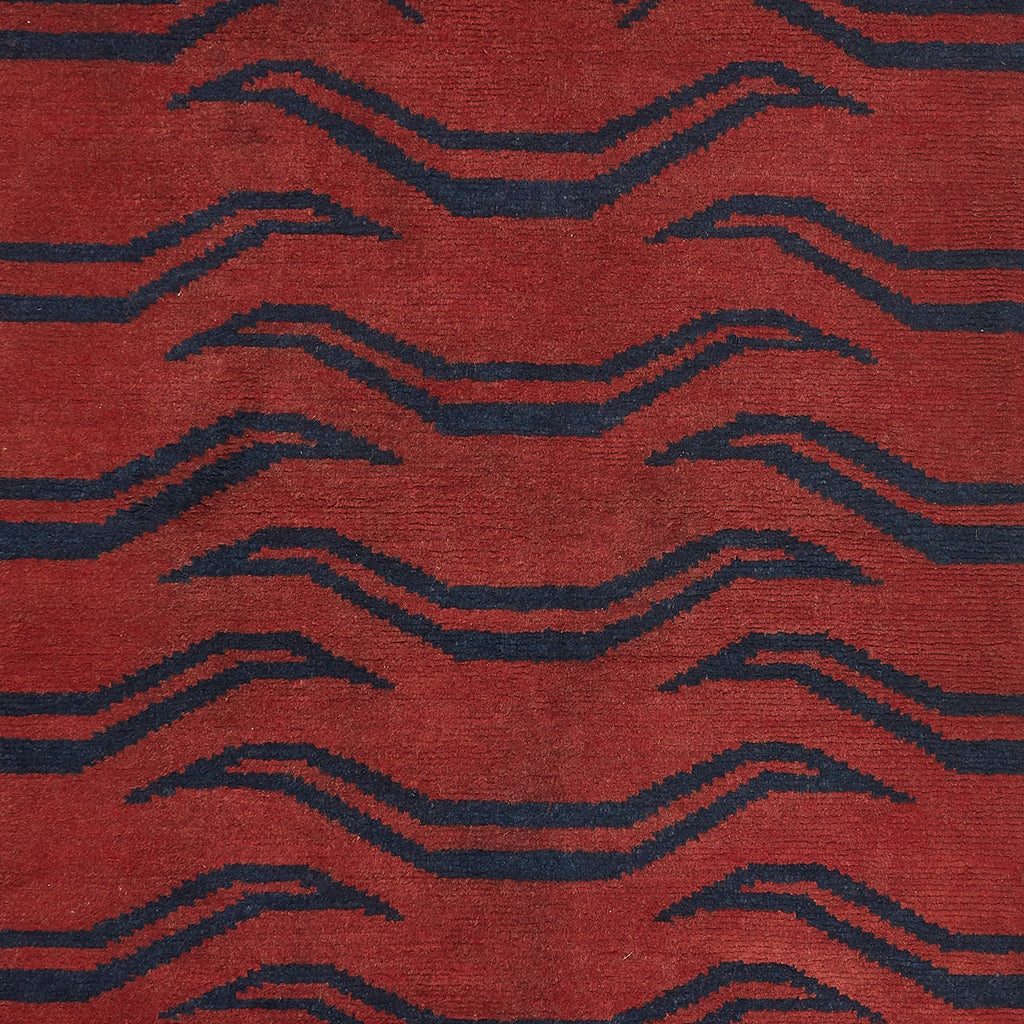 Close-up of bold geometric textile in rich red and blue.