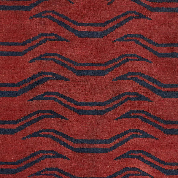 Close-up of bold geometric textile in rich red and blue.