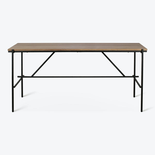 Minimalist, modern table with a warm-toned wooden tabletop and sleek metal frame.