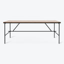 Modern and sleek rectangular table with light wood top and black metal frame and legs.