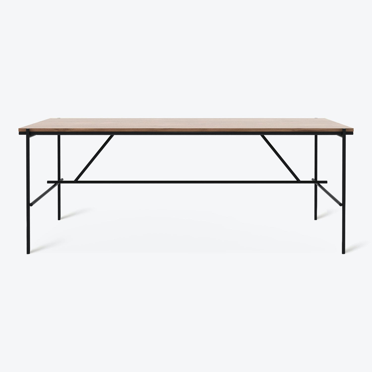 Modern and sleek rectangular table with light wood top and black metal frame and legs.