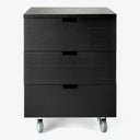 Minimalist black drawer unit on casters with wood grain finish.