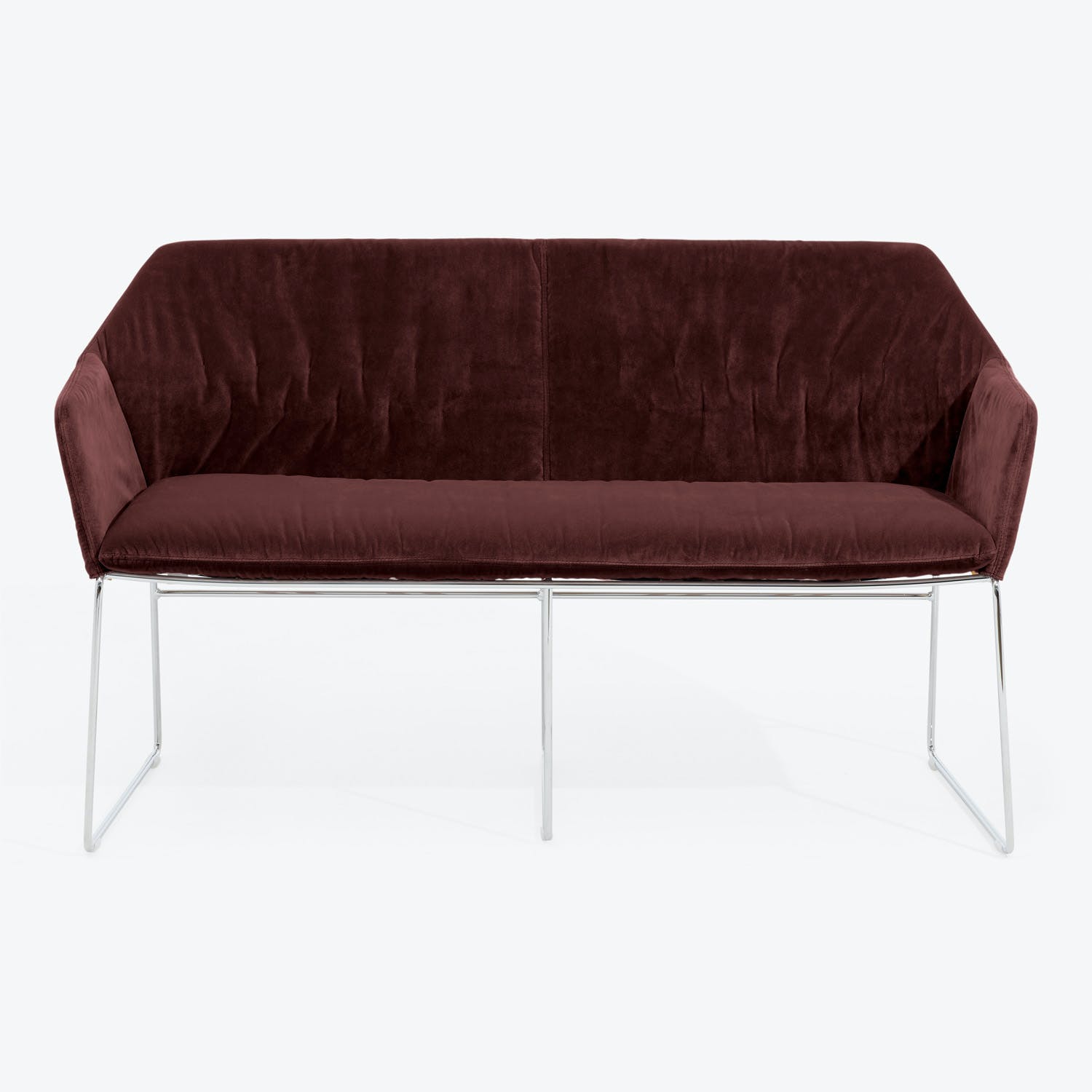 Luxurious burgundy velvet sofa with sleek chrome legs exudes elegance.