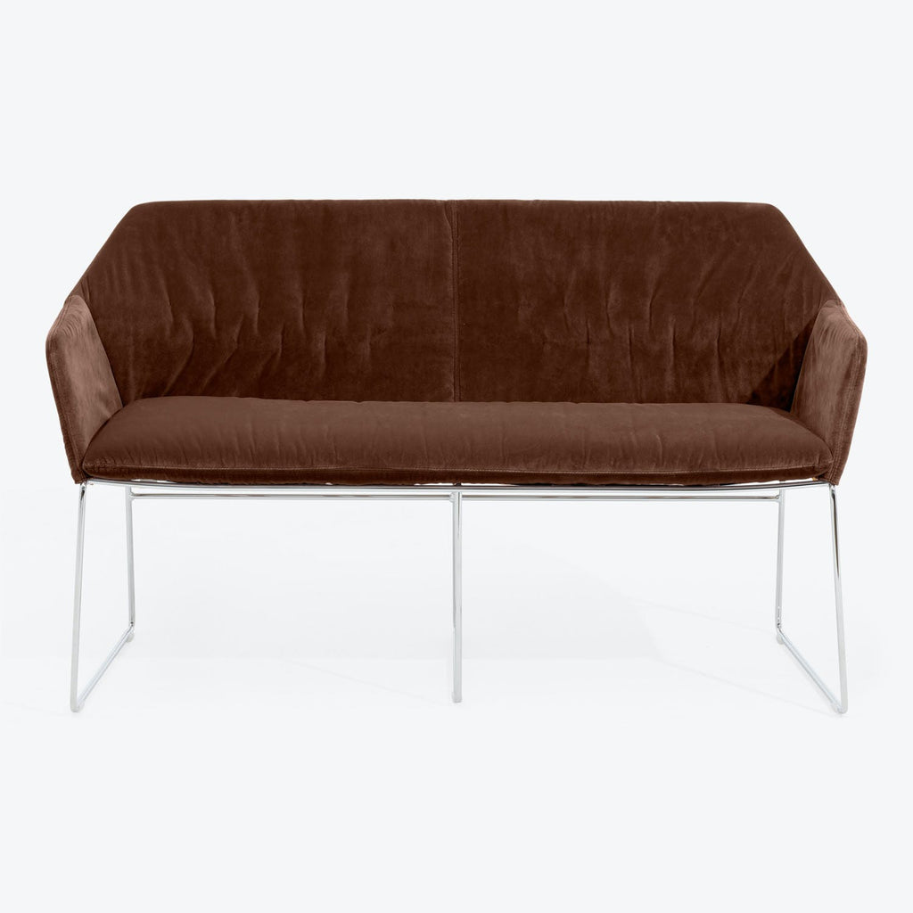 Contemporary brown velvet sofa with unique U-shaped metal frame.