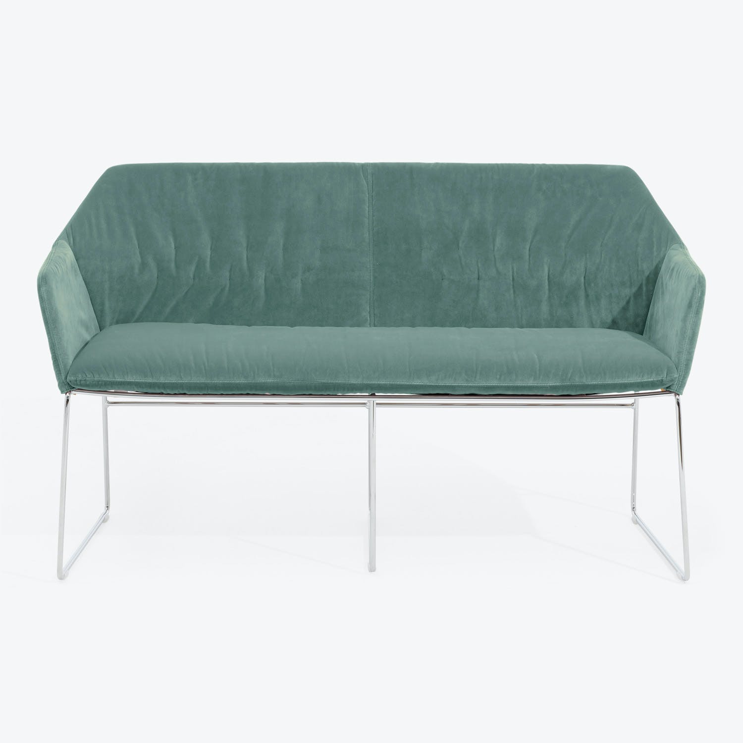 Modern green velvet sofa with sleek metallic legs exudes luxury.
