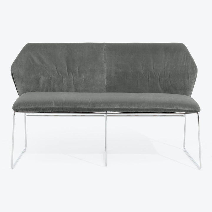 Contemporary grey velvet loveseat with sleek metallic frame for modern homes.